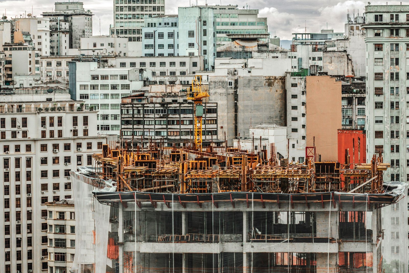 Construction site in São Paulo city with modern high-rise buildings in the background.